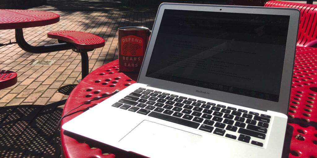 Working on a laptop outside in the sun