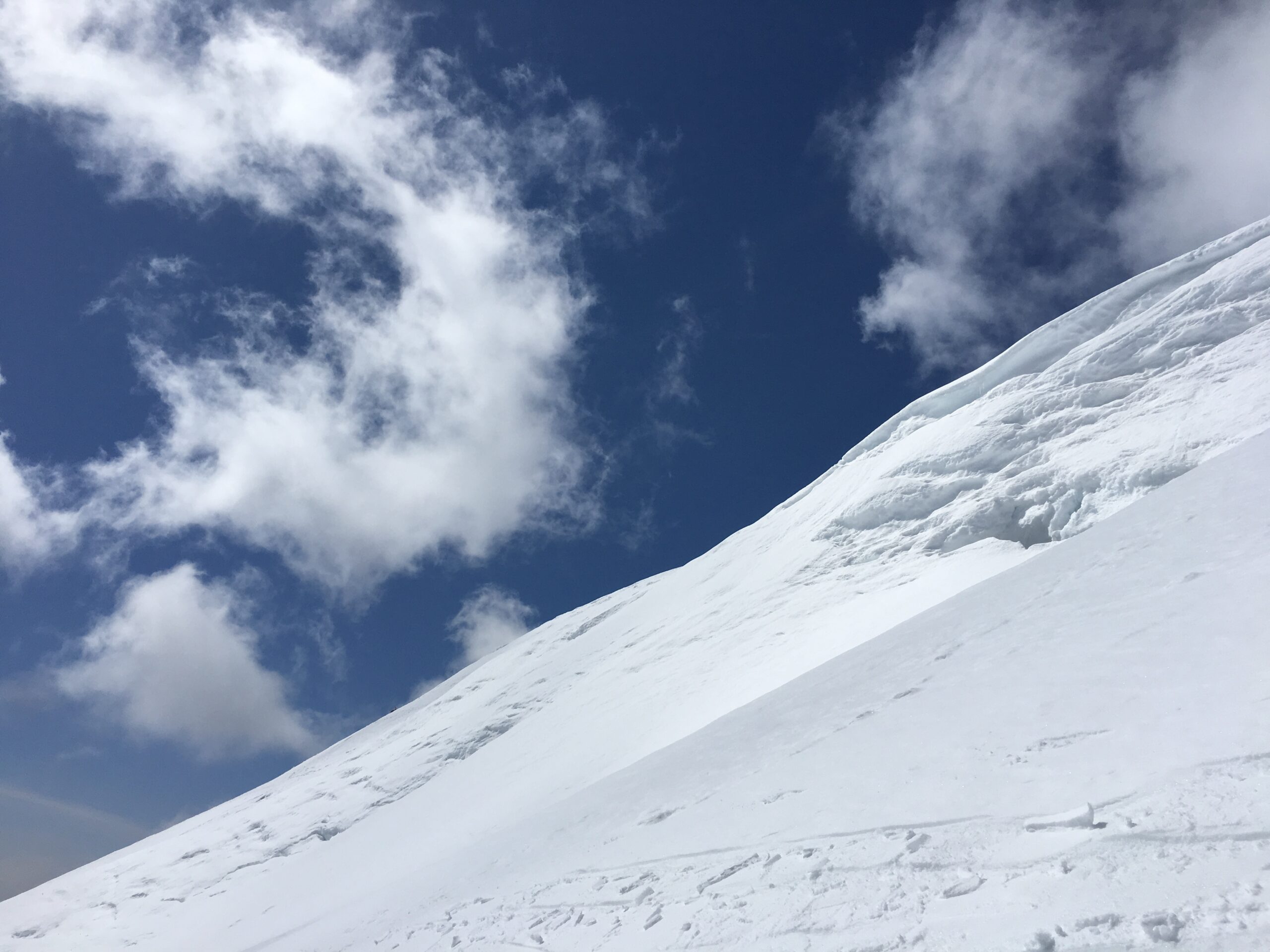 Snow, cornice, clouds and blue sky