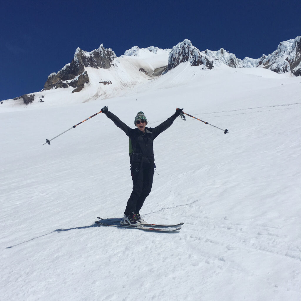 Me posing with my arms and poles out with the mountain behind