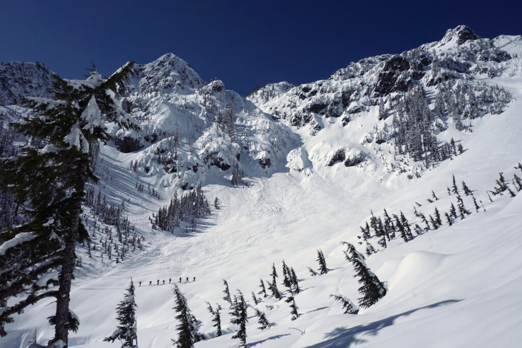 Skiers below avalanche paths